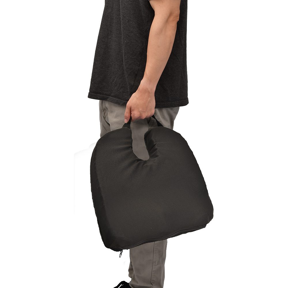 Person carrying black portable seat cushion