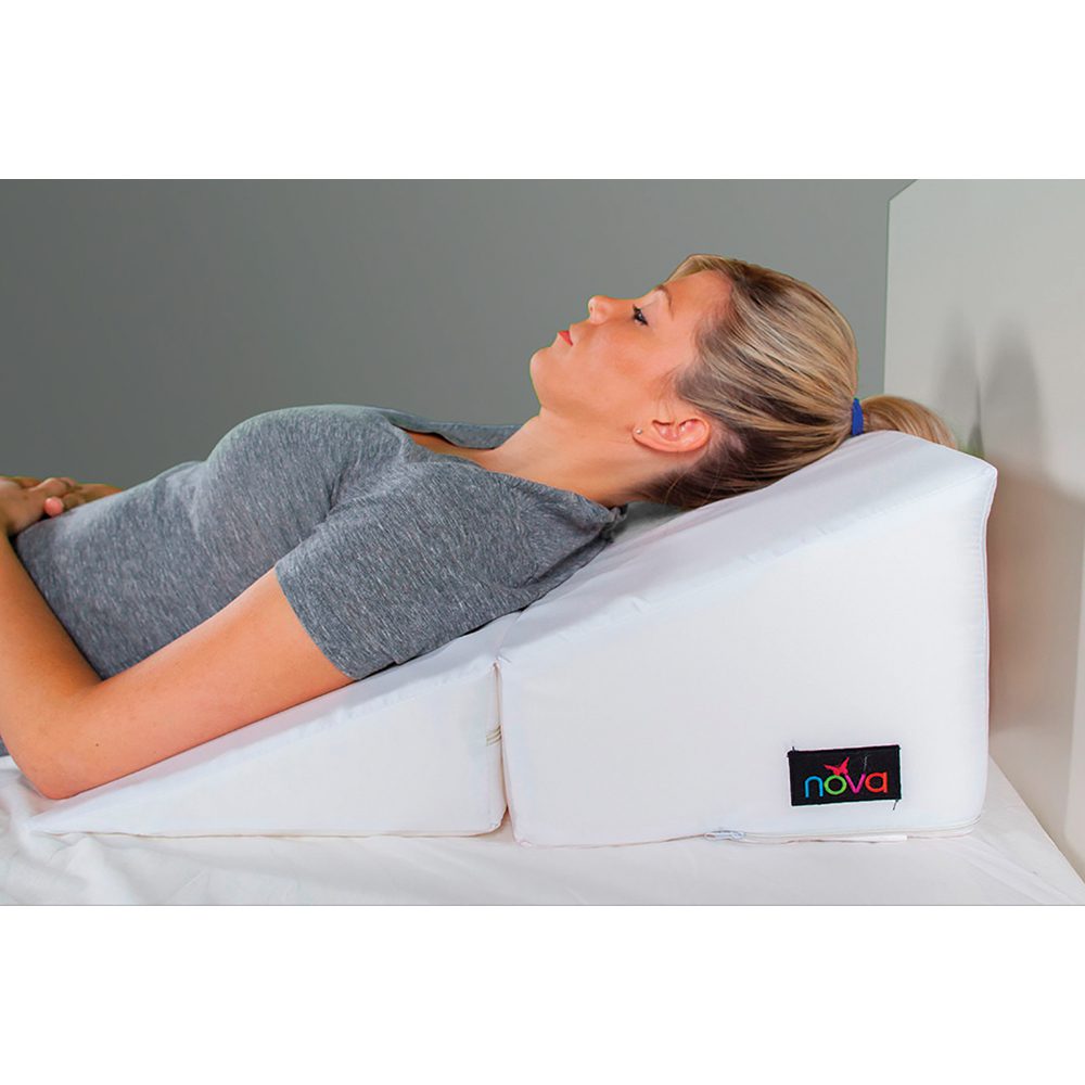 Woman reclining on white wedge pillow