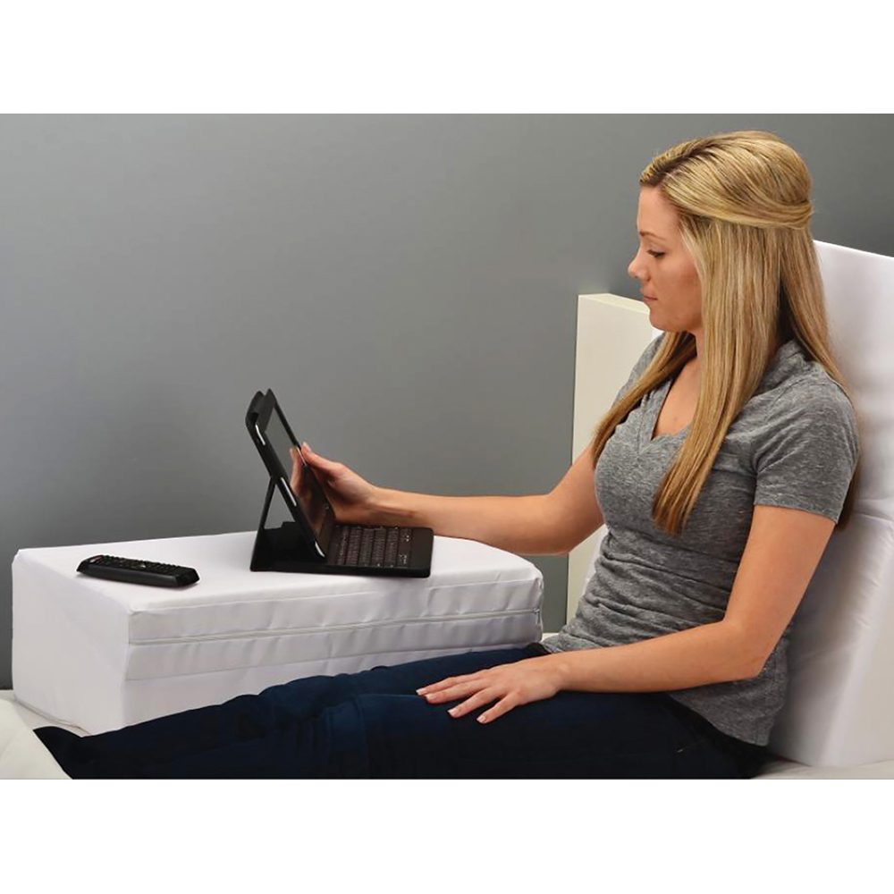 Woman using tablet on lap cushion