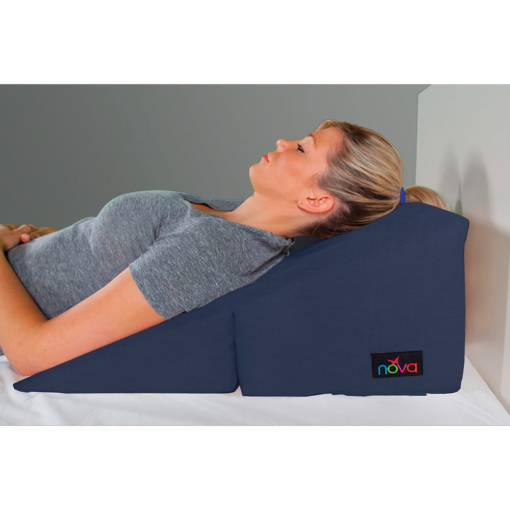 Woman resting on navy incline wedge pillow