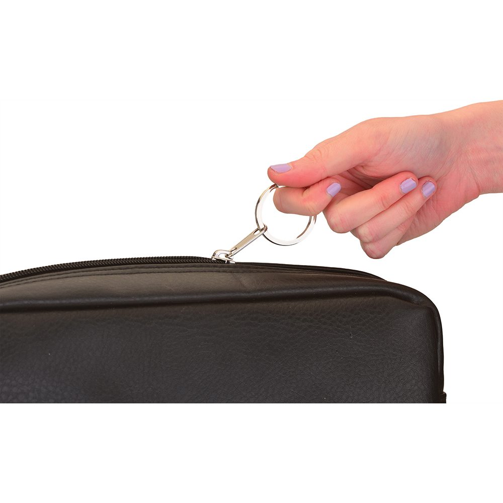Hand pulling zipper on black leather bag