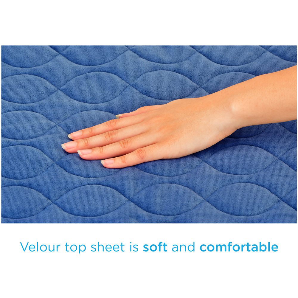 Hand pressing soft blue velour mattress topper